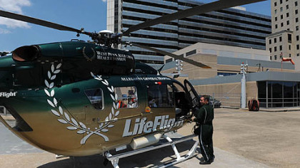 Pilot Dave Murphy checks over his LifeFlight helicopter on the landing pad at Allegheny General Hospital.