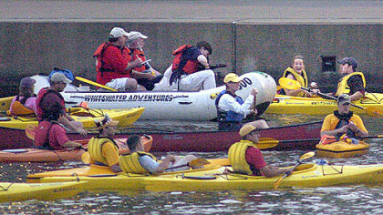 Mike Peters, right, and his girlfriend, holding baseball, are interviewed by Post-Gazette reporter Dan Majors and two other reporters (wearing red on the white raft) after Mr. Peters caught the first baseball hit out of PNC Park during the 2006 Home Run Derby.