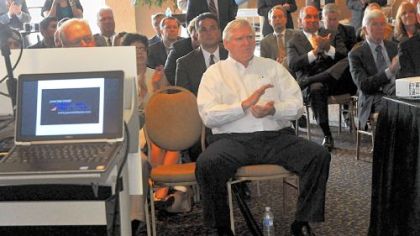 Doug Farnham watches a video presentation about coal production during the press conference.