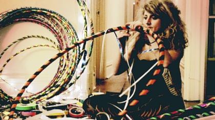 Artist Stefanie Moser decorates the hoops she'll use in a performance of hoop dancing.