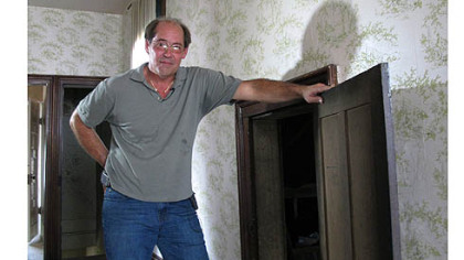 Karl Kissner stands in front of the door in his grandfather's Defiance, Ohio, home.