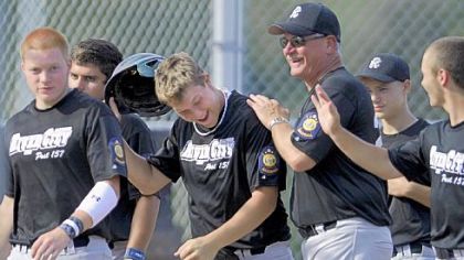 River City's Rob Hardy, left, is congratulated after hitting a three-run home run against Blackhawk Monday evening.