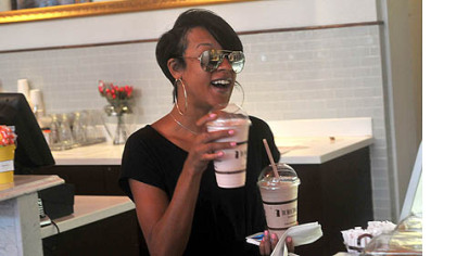 Sasha Ligons from the North Side balances a vanilla and a strawberry milkshake at the start of happy hour at The Milk Shake Factory.