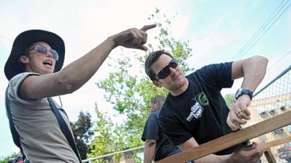 Marisa Manheim, left, the city growing coordinator for Grow Pittsburgh, and Adam Gardner, a guitarist and vocalist for the band Guster, work on creating a compost bin at the Homewood YMCA's community garden on Thursday.