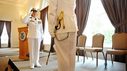 Incoming Commander Lindsay Weaver, relieves Commander Richard Timme of his post during a US Coast Guard MSU Change of Command Ceremony held at the University Club in Oakland on Friday, July 13, 2012.