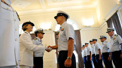 Incoming Commander Lindsay Weaver, left, shakes hands with members of her unit during a traditional inspection of personnel during a US Coast Guard MSU Change of Command Ceremony held at the University Club in Oakland on Friday, July 13, 2012.  Weaver will be the first female commanding officer of the US Coast Guard MSU in Pittsburgh.