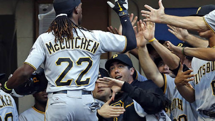 Andrew McCutchen is greeted by his teammates at the dugout after he hit a two-run home run off Milwaukee Brewers' Marco Estrada during the third inning.