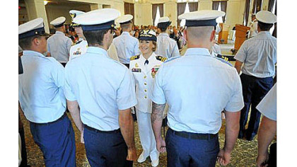 Incoming commander Lindsay N. Weaver, center, greets members of her unit during a traditional inspection of personnel during the Coast Guard change of command ceremony at the University Club in Oakland on Friday. Cmdr. Weaver will be the first female commanding officer and the first Latina top officer at Pittsburgh's Marine Safety Unit.
