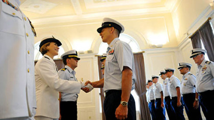 Incoming Commander Lindsay Weaver, left, shakes hands with members of her unit during a traditional inspection of personnel during a US Coast Guard MSU Change of Command Ceremony held at the University Club in Oakland on Friday, July 13, 2012.  Weaver will be the first female commanding officer of the US Coast Guard MSU in Pittsburgh.