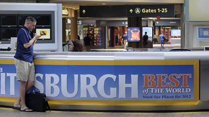 A traveler gets questions answered at the information desk at Pittsburgh International Airport.