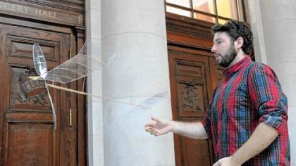 Ben Saks, who works in Carnegie Mellon's architecture department, flies an ultra light plane at the College of Fine Arts building. The plane weighs 1.2 grams and is made of microfilm and balsawood.