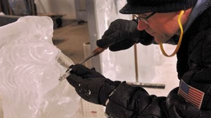 Dan Shaffer, an ice sculptor for the Mastro Ice Co., wears gloves as he works in a freezer room at the Herron Avenue company on a display piece to be sent to a local golf club.
