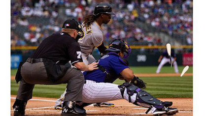 Andrew McCutchen shatters his bat en route to grounding out in the first inning as Rockies catcher Wilin Rosario and home plate umpire Mike Muchlinski look on.