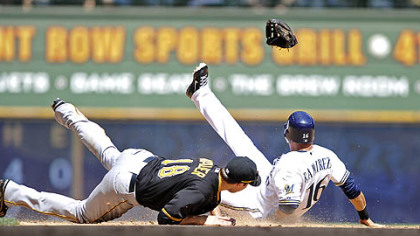 The Pirates' Neil Walker gets his glove kicked out of his hand by the Brewers' Aramis Ramirez as he steals second base during the sixth inning.