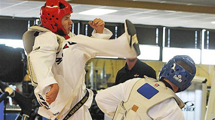 John Haney Jr., left, demonstrates a kick to the head of Ryan McCall at the Army's World Class Athlete training center at Fort Carson, Colo., on Monday, July 16, 2012. The U.S. Army is sending 11 soldiers to the Olympics.