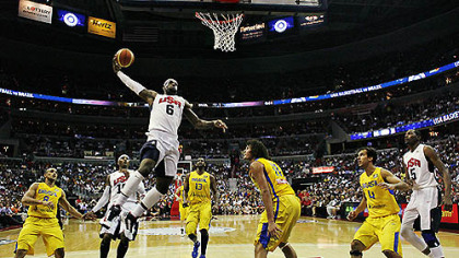 Team USA forward LeBron James goes up for a dunk in front of Brazil forward Anderson Varejao during the first half of an Olympic men's exhibition basketball game, July 16, 2012, in Washington. USA won 80-69.