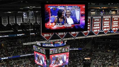 President Barack Obama and first lady Michelle Obama are seen on the in-house television monitors during the 'Kiss Cam' segment as they attend the U.S. men's Olympic basketball exhibition game between Team USA and Brazil in Washington, Monday, July 16, 2012.