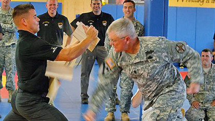 Sgt. Major Donald Felt demonstrates breaking boards being held by SFC David Bartlett at the Army's World Class Athlete training center at Fort Carson, Colo., on Monday, July 16, 2012. The U.S. Army is sending 11 soldiers to the Olympics. The soldiers include both coaches and athletes competing in wrestling, shooting, race walking, the modern pentathlon and boxing.