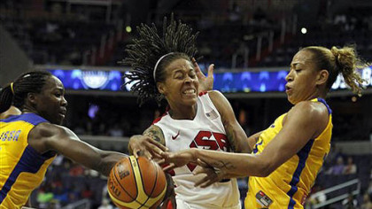 Team USA forward Seimone Augustus, center, struggles with the ball between Brazil centers Erika Cristina Dos Souza, left, and Clarissa Cristina De Santos during the first half of an Olympic women's exhibition basketball game, Monday, July 16, 2012, in Washington.