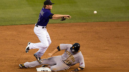 Rockies shortstop Josh Rutledge throws to first base after getting lead runner Neil Walker on a fielder's choice during the fifth inning.