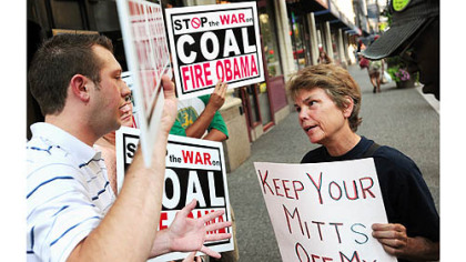 Marcia Bandes, right, of Squirrel Hill converses with a counter-protester Tuesday outside the Duquesne Club, Downtown, where Republican presidential candidate Mitt Romney was attending a private fundraiser.