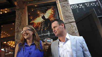 Dawn Keezer the director of the Pittsburgh Film Office, and Mayor Luke Ravenstahl pose for photographs before a special preview screening of "The Dark Knight Rises",at the Byham Theater