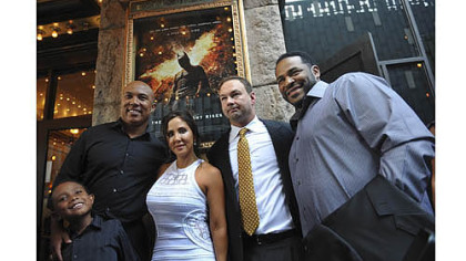 From left, Jaydon Ward and his father Hines Ward, Alba and Thomas Tull and Jerome Bettis pose for photographs before a special preview screening of "The Dark Knight Rises".