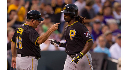 Andrew McCutchen is congratulated by third base coach Nick Leyva  after hitting a home run during the fourth inning against the Colorado Rockies.