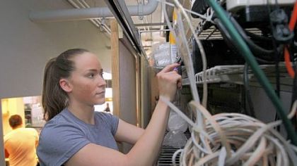 Manager Meghan Gormley adjusts levels on the pre-amp for the Prescriptive  Music system at the Local Cafe in Oakland, Calif.
