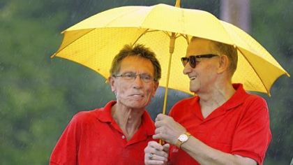 Jim Vehar, 70, and Moe Rankl, 72, both of Bethel Park, take shelter from the rain Sunday at a dedication commemorating the former Heidelberg Raceway and Sports Arena. The men started as firefighters at the old raceway in 1965.
