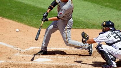 Pirates' Garrett Jones hits a three-run home run during the third inning as Rockies catcher Ramon Hernandez looks on at Coors Field in Denver, Colorado.