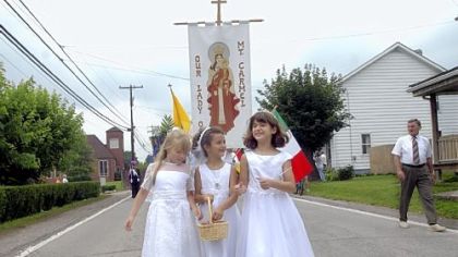 In 2004: From left, Jenny Bell, 8, Courtney Hetherton, 7, and Alexa Stynchula, 8, throw flower petals during the Our Lady of Mount Carmel procession along Route 119 in Crabtree.