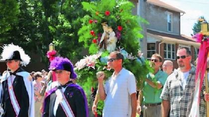 Men carry the statue of Our Lady of Mount Carmel in the procession from St. Bartholomew Catholic Church in the 100th anniversary of the event last year.