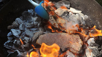 After first sides of steaks are seared, turn the meat to finish the second side.