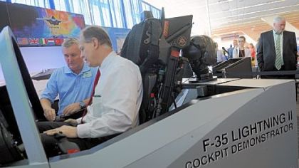 Flight instructor Tony Stutts, left, gives U.S. Rep. Mark Critz, D-Johnstown, a lesson in an F-35 flight simulator Monday at the National Association of Counties annual conference at the David L. Lawrence Convention Center.