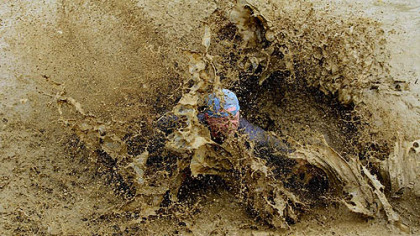 Mud runs pile on the slop as athletes move along a 5K course in which they slog their way through messy challenges.