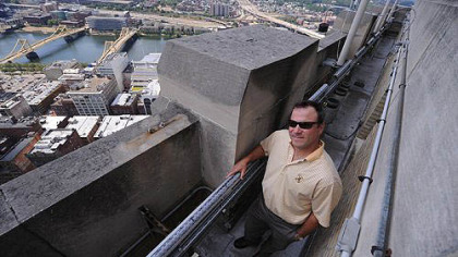 Larry Walsh, senior vice president of Rugby Realty, stands outside the 39th floor of the Gulf Tower near new LED lights that replace the old weather display lights.