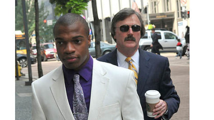 Jordan Miles, left, enters the Federal Courthouse today.