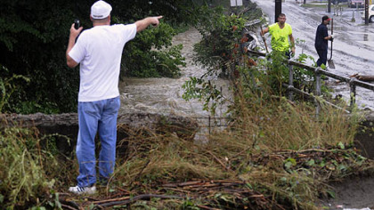 Kevin Quigley, assistant director of Pittsburgh's Department of Public Works directs the clean-up at the intersection of Routes 51 and  88 where Saw Mill Run flooded this afternoon.