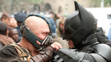 Tom Hardy as Bane and Christian Bale as Batman face off in "The Dark Knight Rises."
