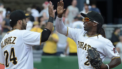 Pedro Alvarez high fives center fielder Andrew McCutchen after beating the Reds.