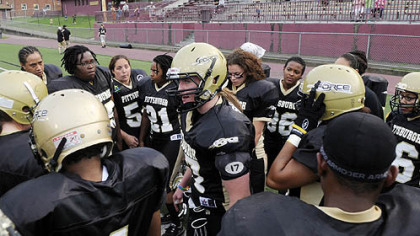 Candice Snyder, the quartarback, tries to fire up her team, the Pittsburgh Force, as they are losing 21-0 at half time to Keystone Assault in women's football.
