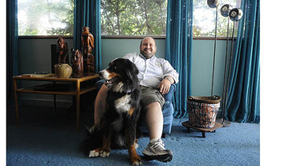 Homeowner Ed Pariser with his dog, Otto, in the home designed by Richard Neutra.