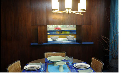 The dining room with a view into the kitchen.