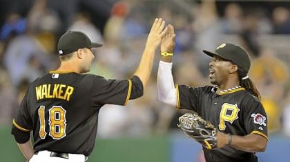 Pirates second baseman Neil Walker celebrates with center fielder Andrew McCutchen after beating the Marlins, 4-3, Friday at PNC Park.