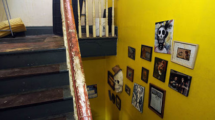 Artwork lines the wall of a stairwell in the Cyberpunk Apocalypse.