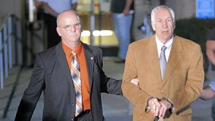 Jerry Sandusky is led out of the Centre County Courthouse after being found guilty of molesting children.