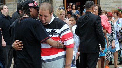 Ron Spence, left, of McKeesport comforts C.J. Sims following the funeral of his brother James Andre Lane Sims outside the New Beginnings Ministry church in McKeesport.