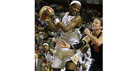 Seattle Storm's Swin Cash, left, grabs a rebound during a WNBA basketball game in 2011.