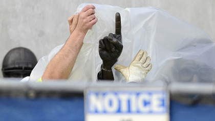 Workers cover up the statue of the late Joe Paterno prior to its removal from outside Beaver Stadium.